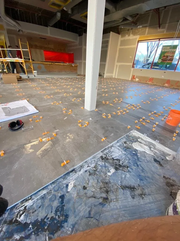 Commercial tile installation in progress for Burger King in Calgary