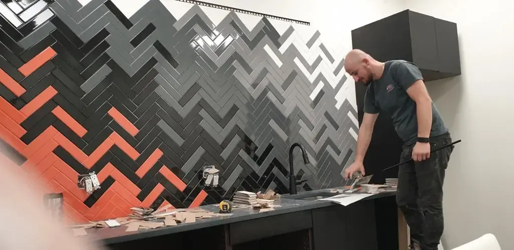 Vladimir Ceci, owner and operator of Vladi Enterprises Ltd., setting a herringbone tile backsplash in Calgary